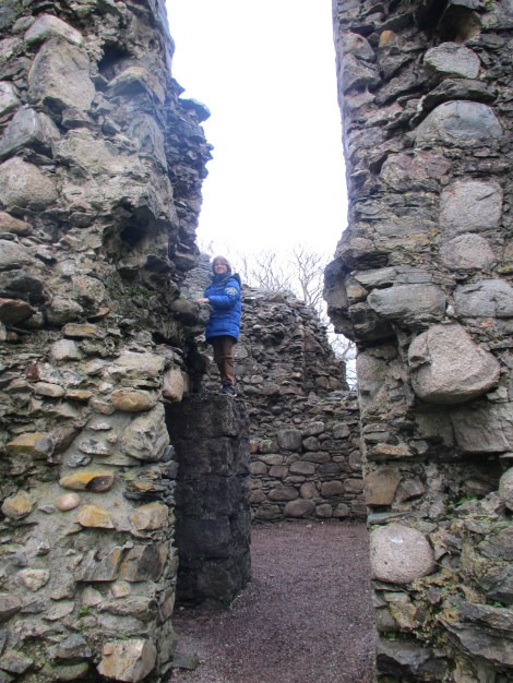 Happy boy climbing on ruins